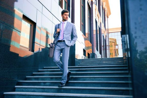 young handsome businessman walking on stairs | Easy Ways To Cut Your Losses in Real Estate Now