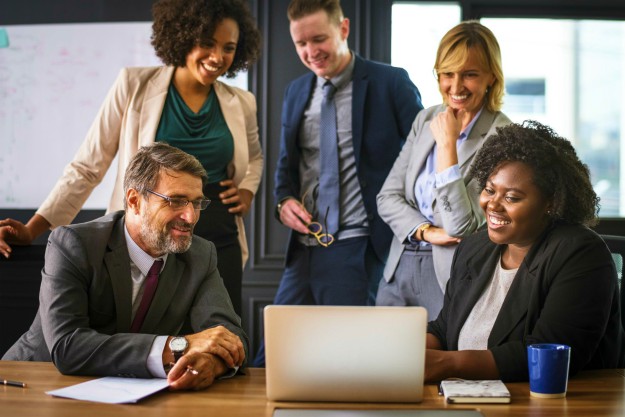 team laptop desk workspace | Keys To Success To Effectively Train Your New Employee | success factors