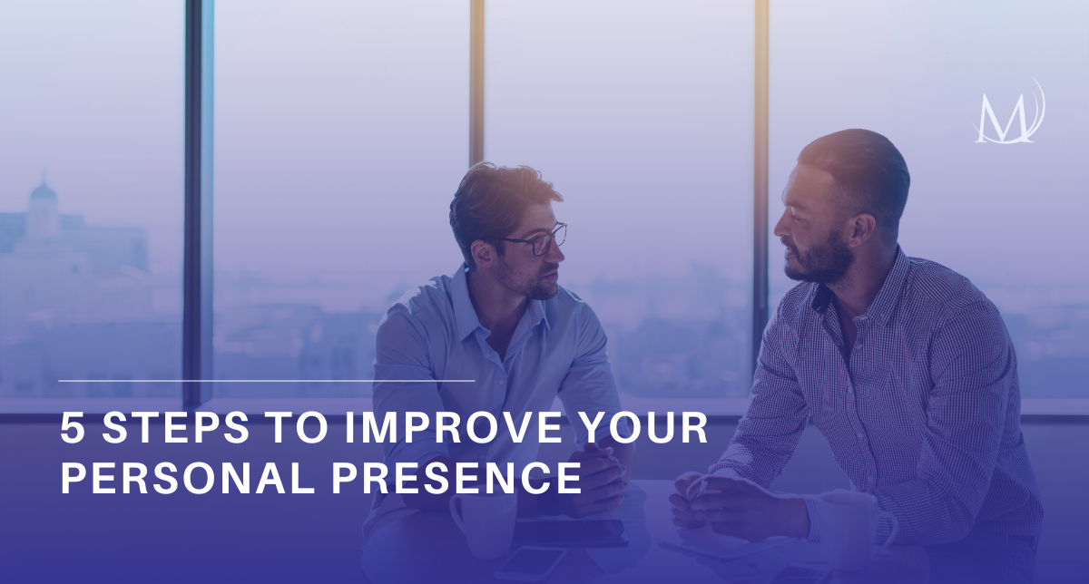 Two professional men in button-down shirts sit at a table in a modern office with large windows, engaged in a discussion. A blue gradient overlay across the bottom features the bold white text, "5 STEPS TO IMPROVE YOUR PERSONAL PRESENCE." A minimalist white "M" logo is positioned in the upper right corner.